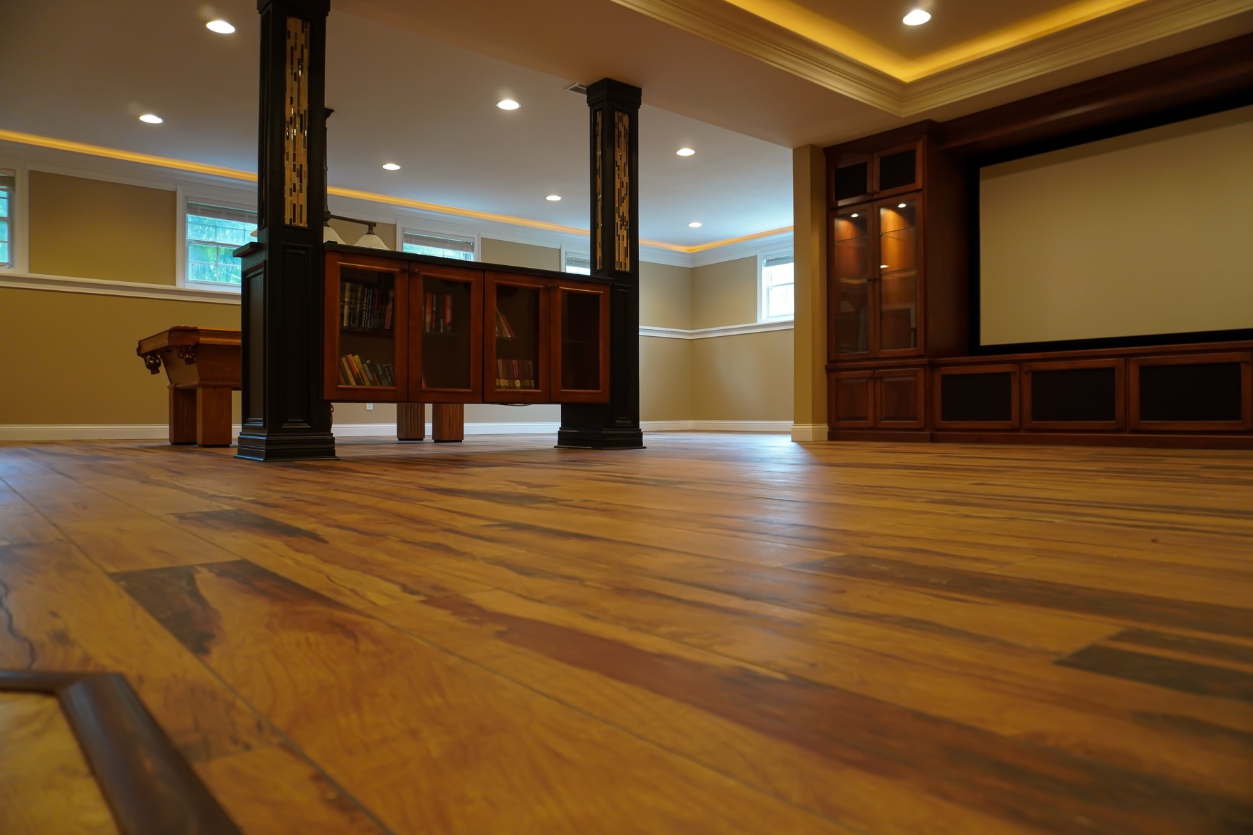 Wood-look tile flooring with custom stone bar