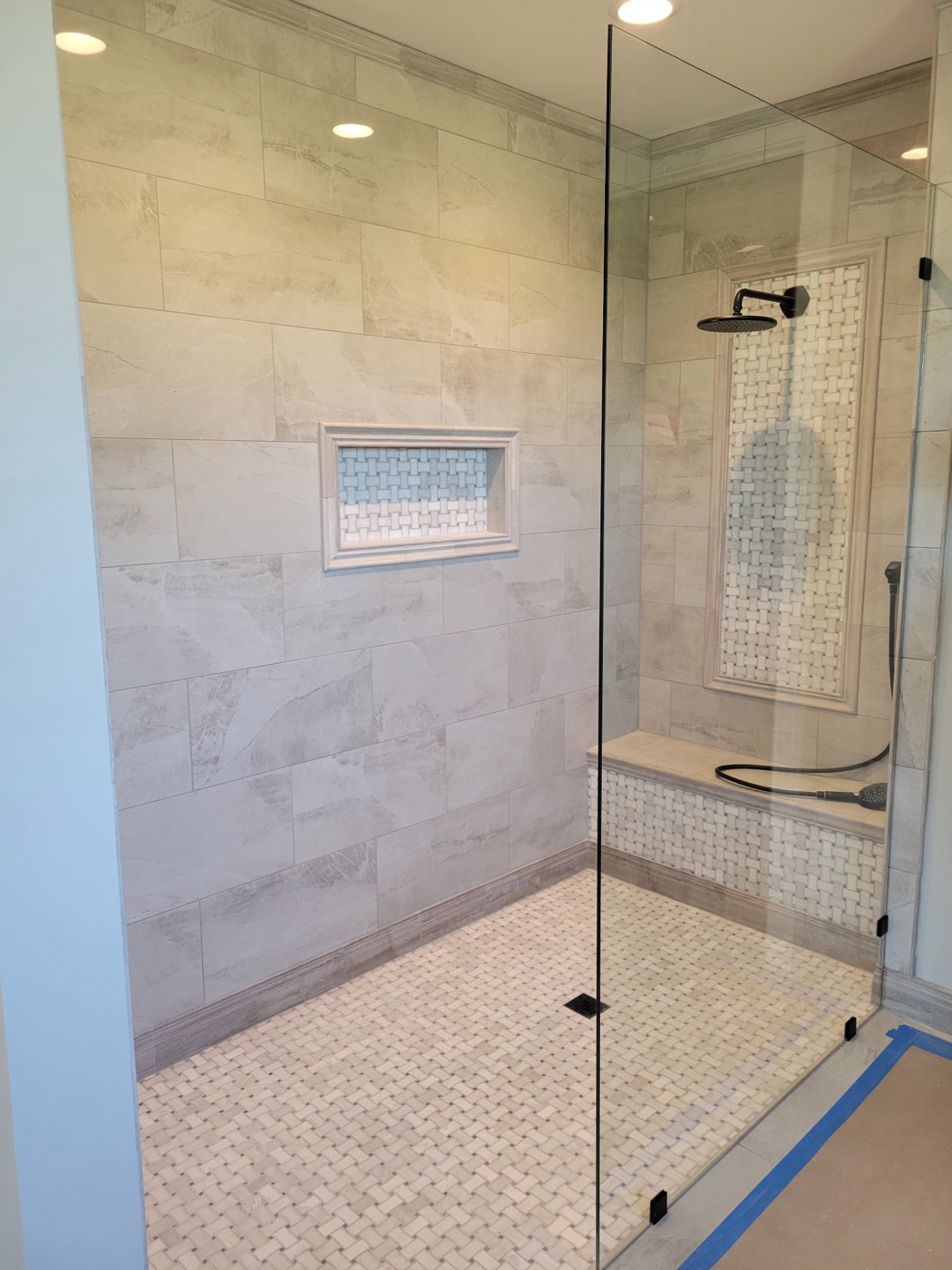 Shower with basketweave mosaic floor