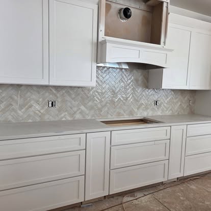 Herringbone marble kitchen backsplash