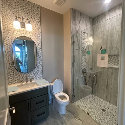 Bathroom with pebble mosaic accent wall