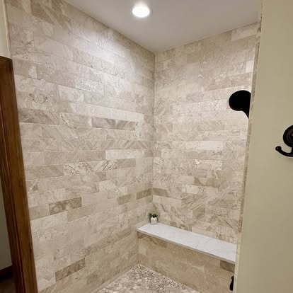 Travertine shower with marble bench